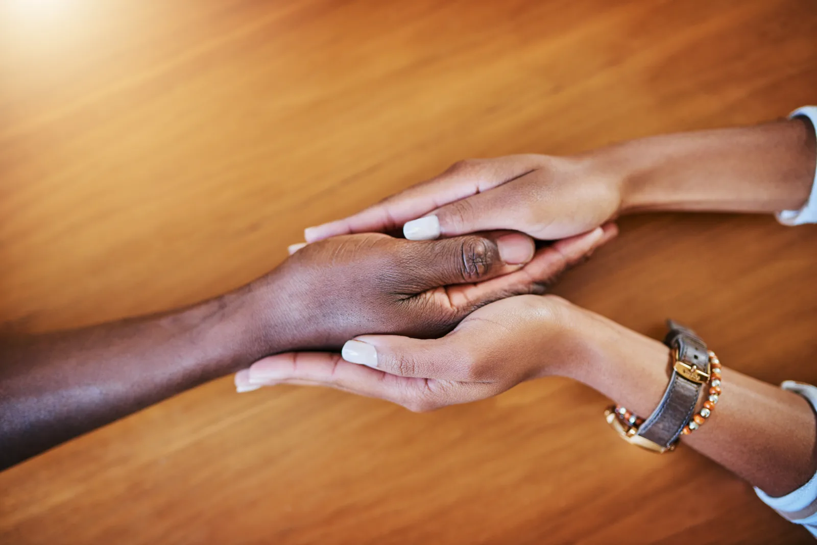 Couple holding hands in a supportive and caring gesture